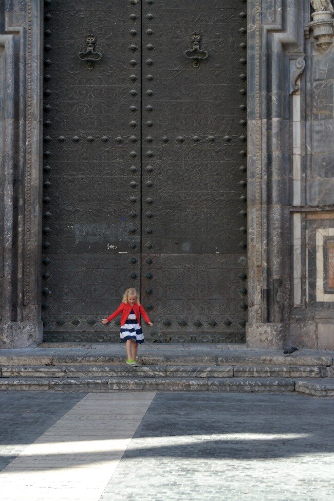 Small girl huge door